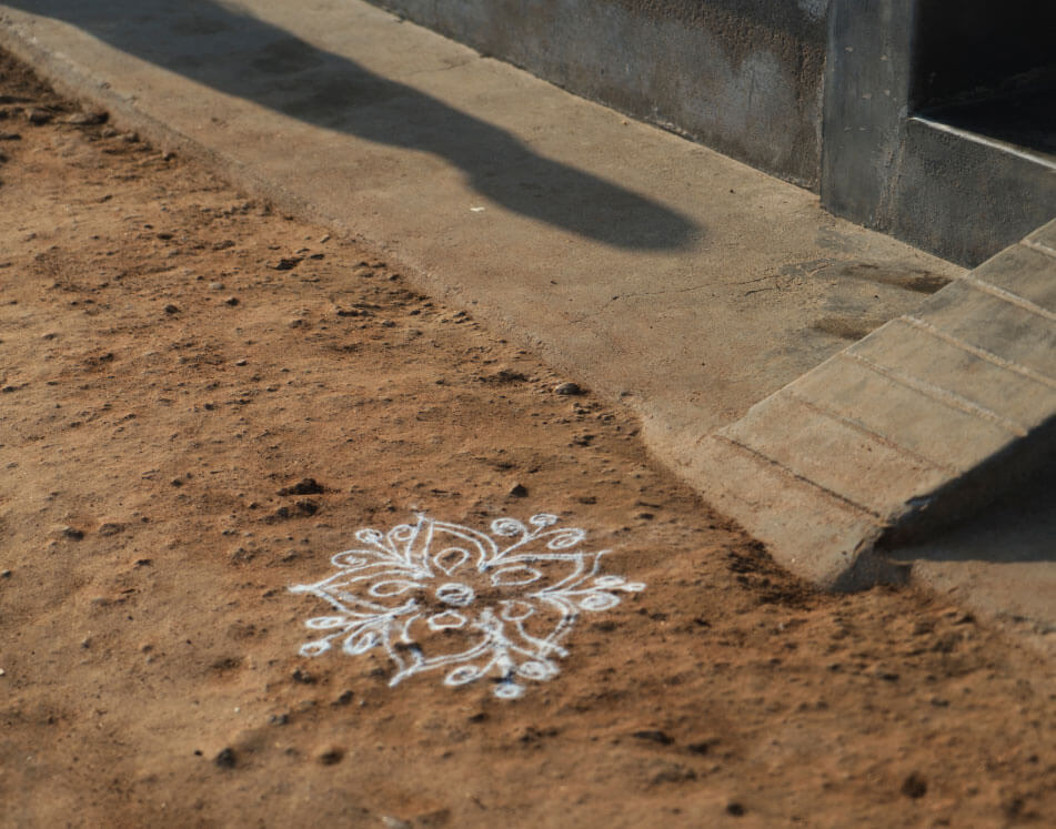 Early each morning after washing, the women in the village create these patterns to bless their homes.